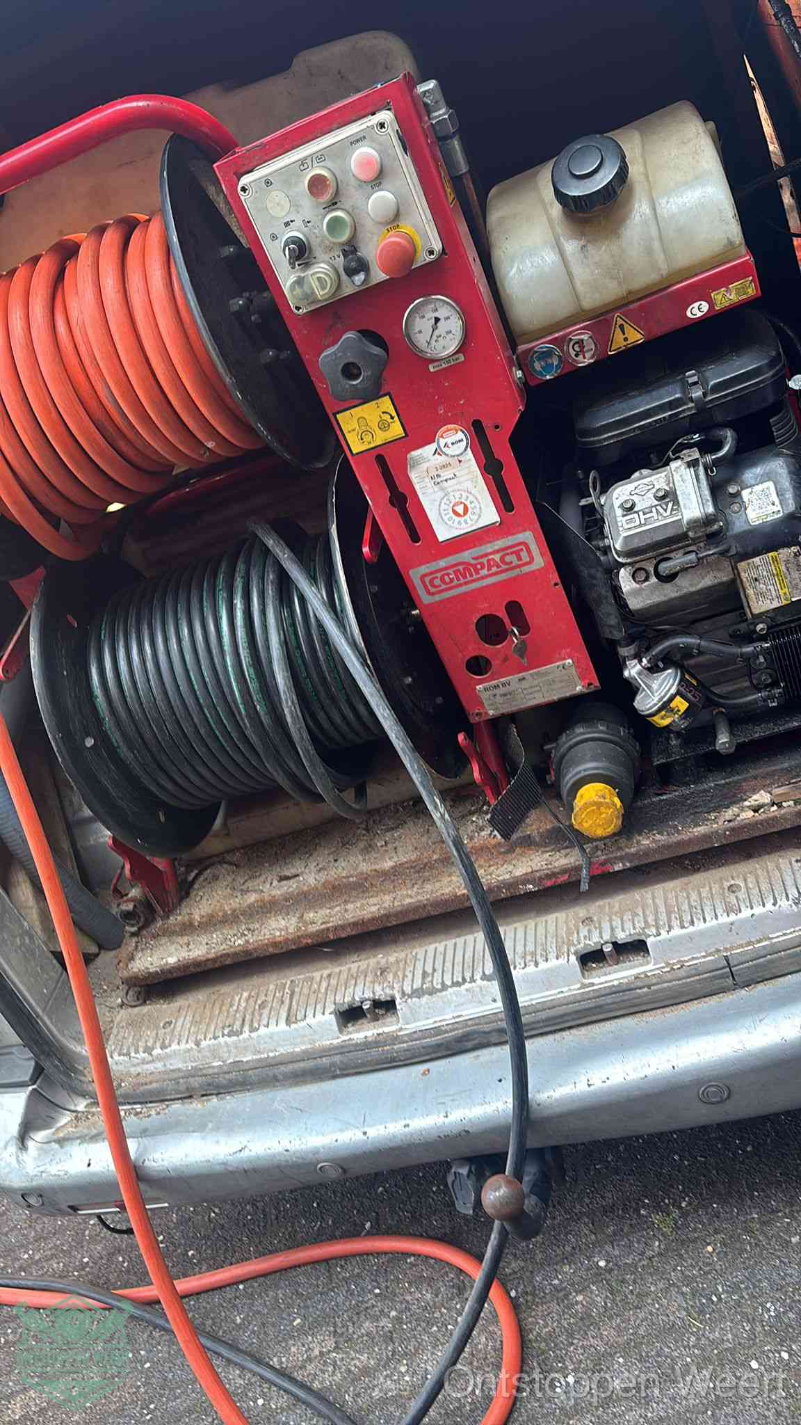 Een rood hogedruk-rioolreinigingstoestel in de laadbak van de bedrijfsbus, apparatuur voor een hardnekkige afvoerverstopping in Weert